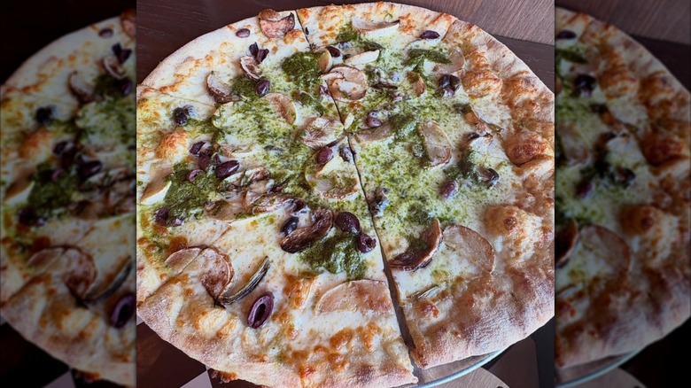 Pie with turnip pesto, kalamata olives, and cheese at Supino Pizzeria