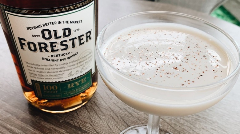Bottle of Old Forester Rye with creamy cocktail
