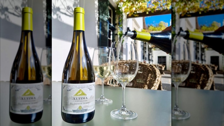 bottle of white wine and pouring white wine into glass