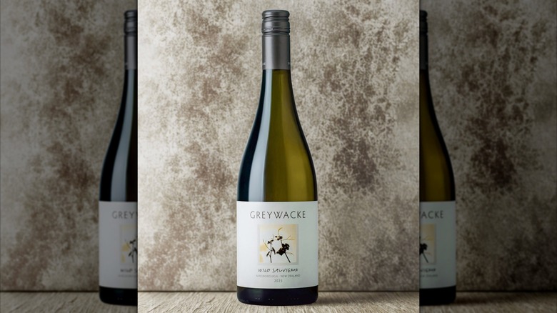 bottle of white wine against gray background