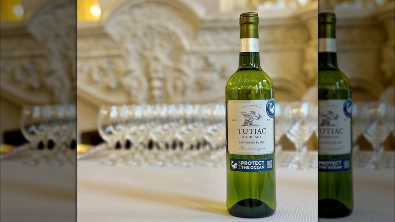 bottle of white wine in front of wine glasses