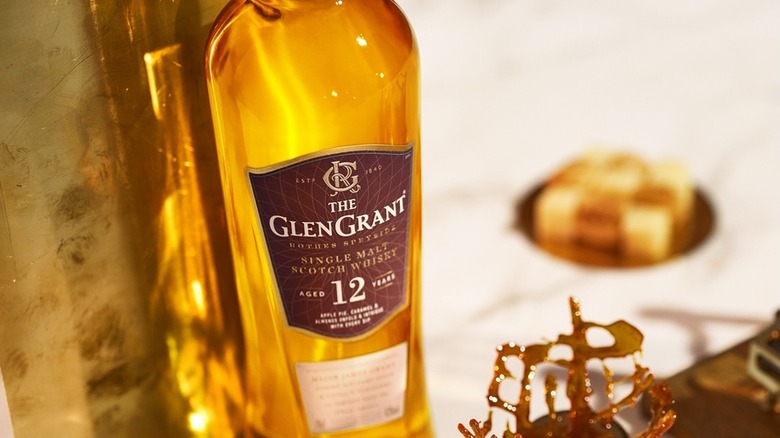 A top down view of a bottle of Glen Grant 12-year with objects blurred in the background