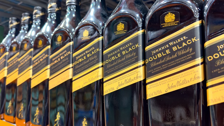 A row of Johnnie Walker Double Black bottles on a store shelf