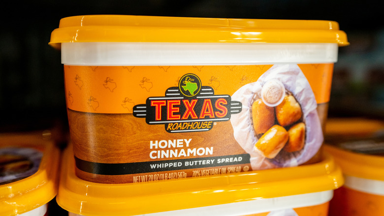 Tubs of Texas Roadhouse buttery spread stocked at a store