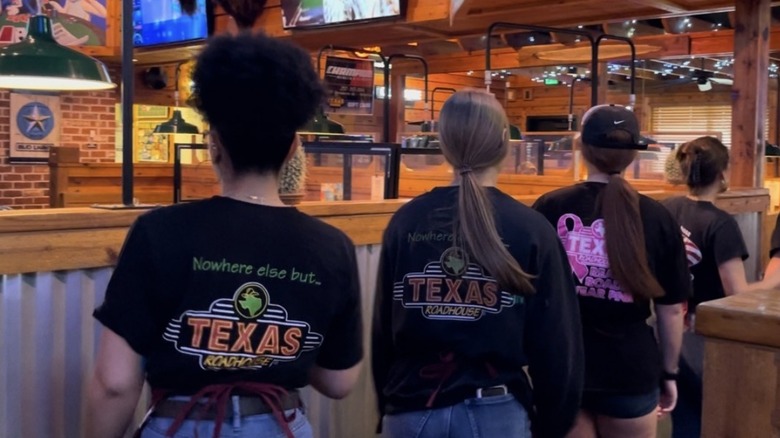 Texas Roadhouse employees line dancing in the aisle
