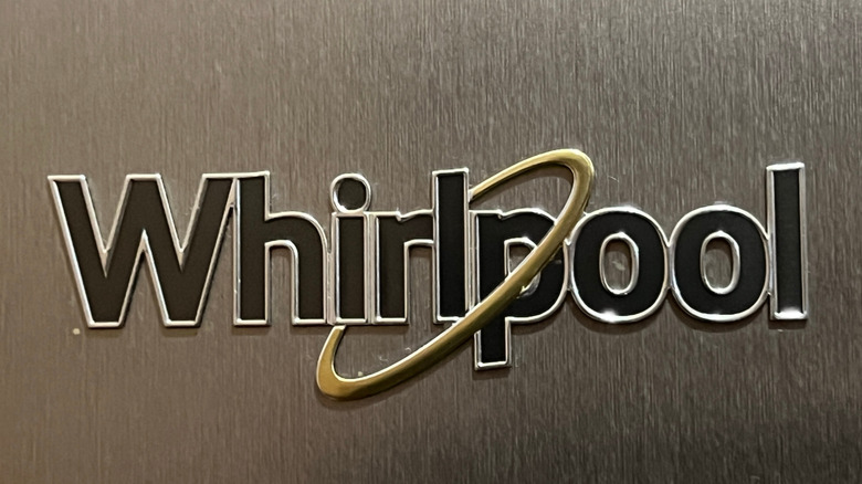 Close-up of the Whirlpool logo on a stainless steel refrigerator