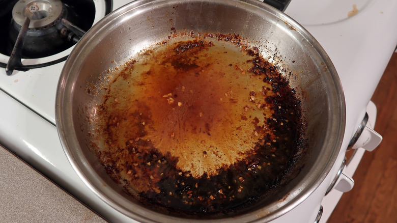 Stainless steel pan with burned on grease and food bits