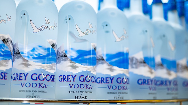 Row of Grey Goose bottles on a store shelf.