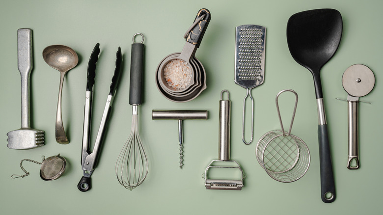 An array of cooking and baking tools laid out on a countertop