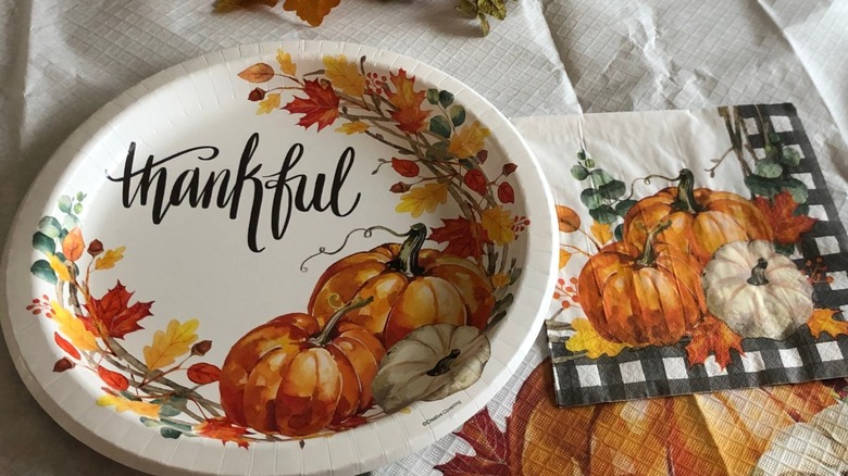 A Thanksgiving table set with festive disposable tableware