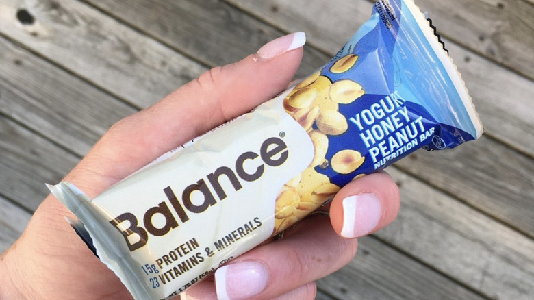 Yogurt Peanut Honey Balance Bar in hand