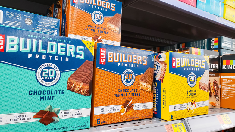 Boxes of Clif Builders Protein Bars on a grocery store shelf