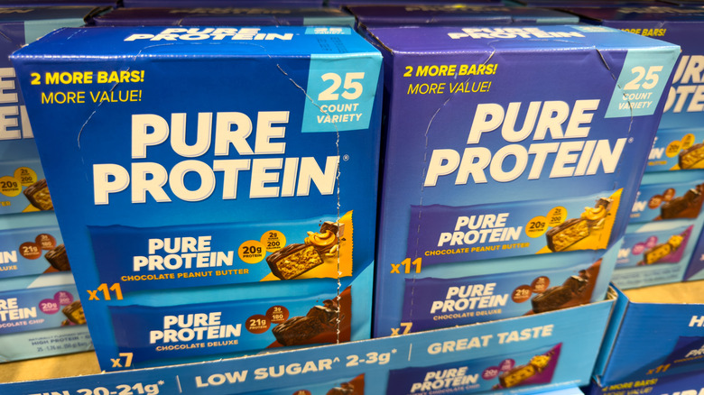 Boxes of Pure Protein Bars on a grocery store shelf