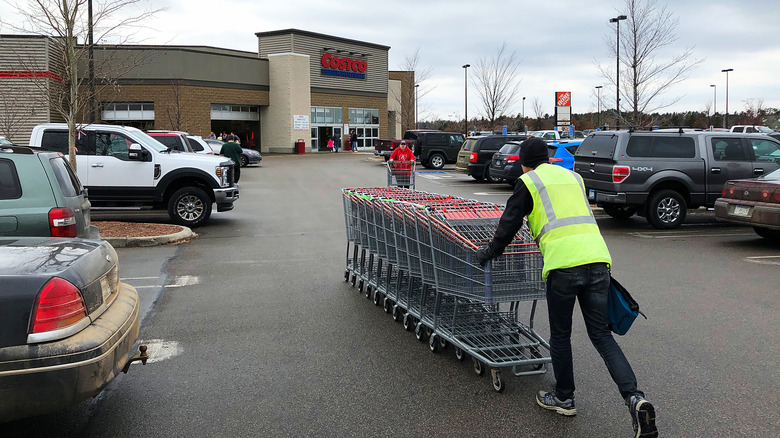 Costco employee putting away carts