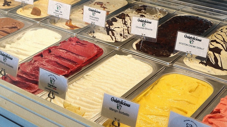 Gelatolicious gelato flavors in tubs behind the counter.