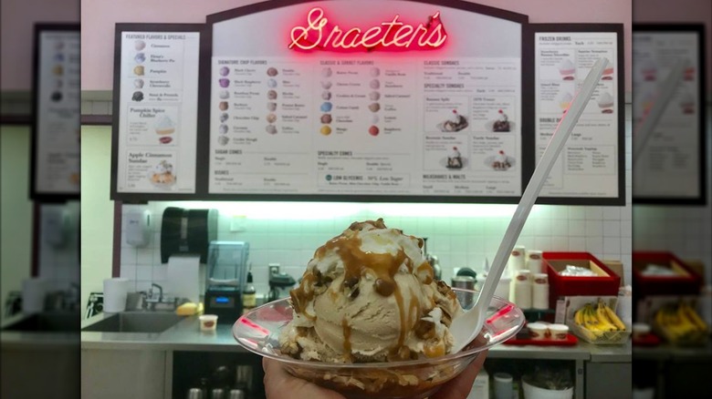 Graeter's ice cream in bowl in front of the menu board.