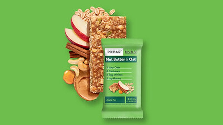 RXBAR Nut Butter & Oat Apple Pie with ingredients against a bright green background.
