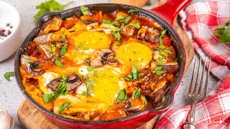 poached eggs in sauce with mushrooms