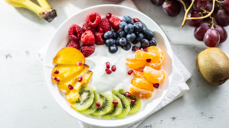yogurt bowl with kiwi, raspberry, blueberry, mandarin orange, and peach