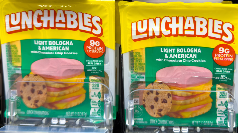 Two packs of light bologna and American with chocolate chip cookies Lunchables on a store shelf