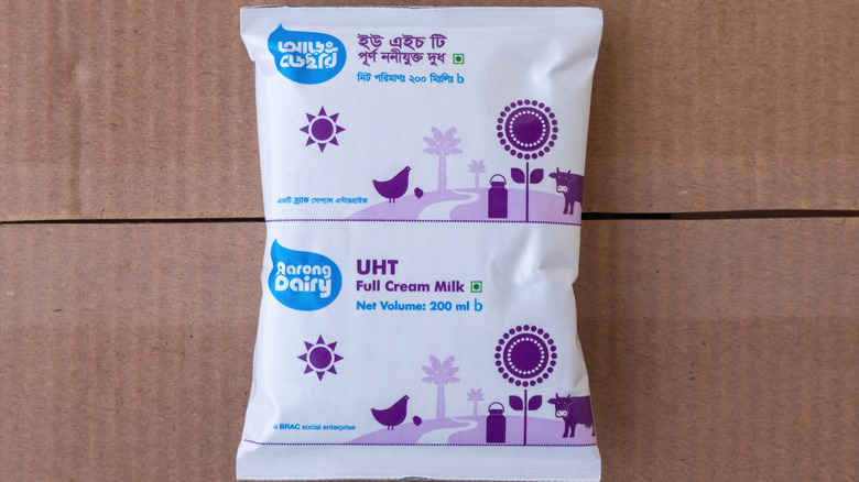 A bag of UHT full cream milk on top of a cardboard box