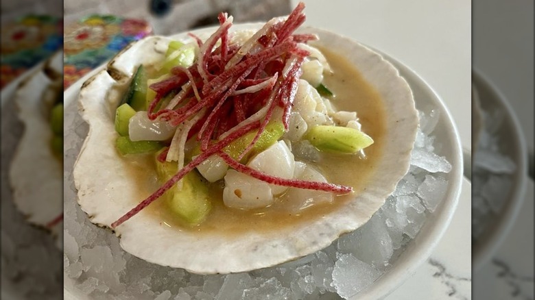 Scallop in a shell with garnish on ice from a Bay Area seafood restaurant