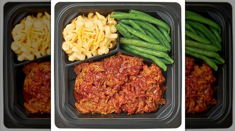 Top view of a meal trat with pulled pork, mac and cheese, and green beans.