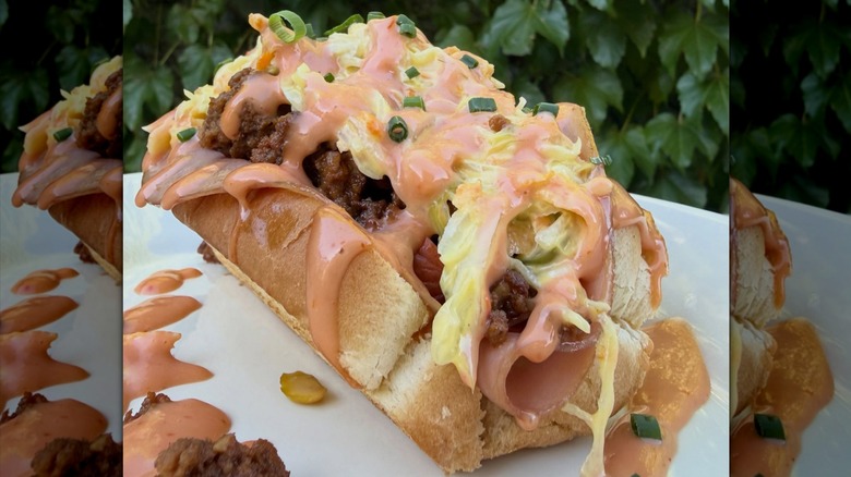 Loaded mortadella hot dog on white surface