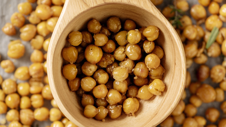 Crispy roasted chickpeas in wooden scoop