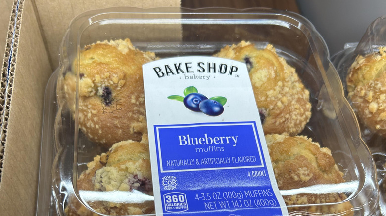 Plastic clamshell container of Blueberry Muffins in an Aldi store