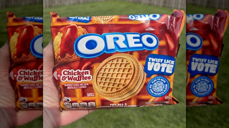 Hand holding package of Chicken & Waffles Oreo