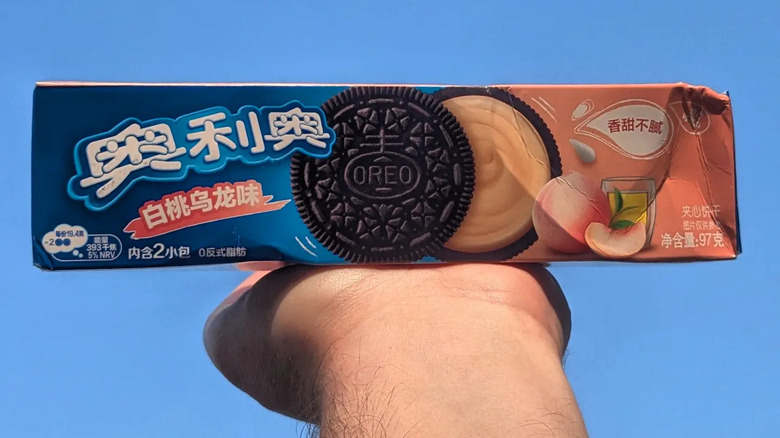 Hand holding package of Peach Oolong Tea Oreos