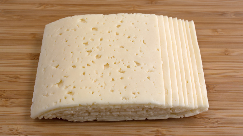 slices of havarti on a wooden board