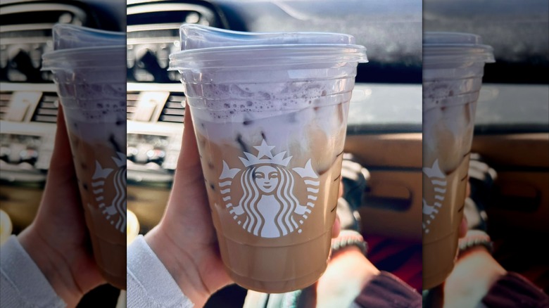 close up of woman holding Starbucks Iced Lavender Cream Chai in car