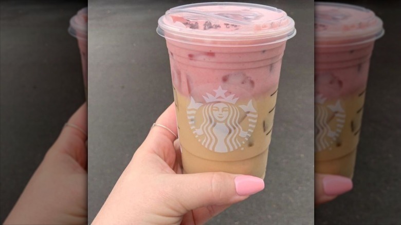 close up of woman holding Starbucks White Chocolate Strawberry Cream Cold Brew in hand