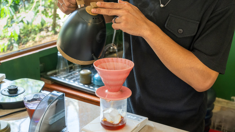 A person using the flash brew coffee method.