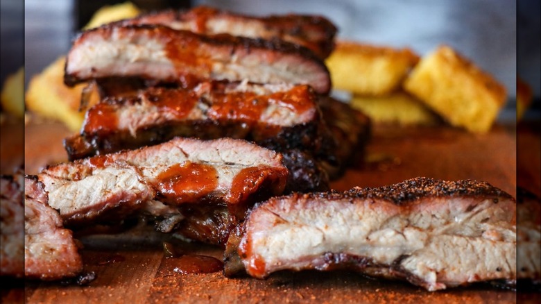 Ribs cross-section with BBQ sauce on wooden board