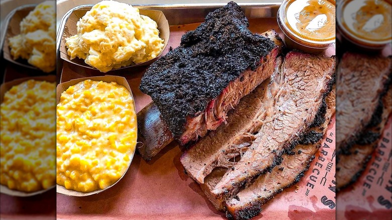 Beef ribs and brisket on tray with corn and potatoes