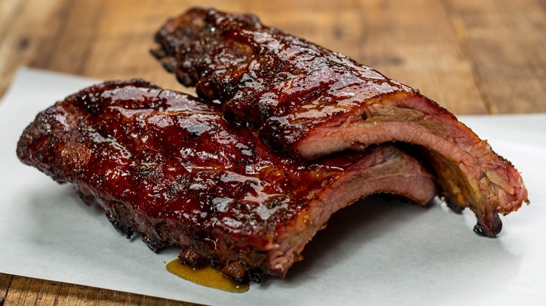 BBQ ribs on paper on wood table