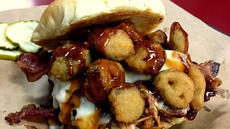 Rocket pig sandwich with fried jalapenos on paper