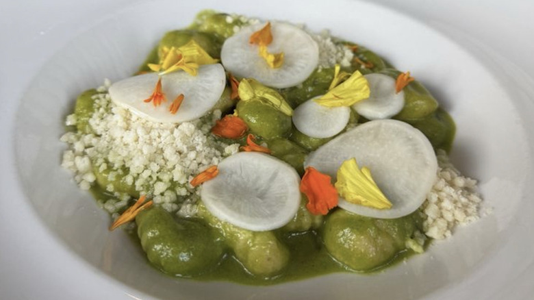 Gnocchi with flowers and pesto on top from Italian restaurant Il Nido in Seattle