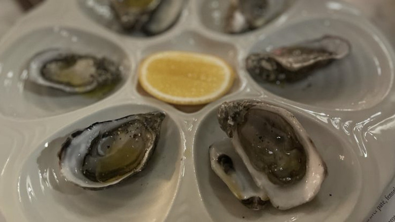 Up-close shot of oyster platter with a lemon in the middle from a Seattle Italian restaurant