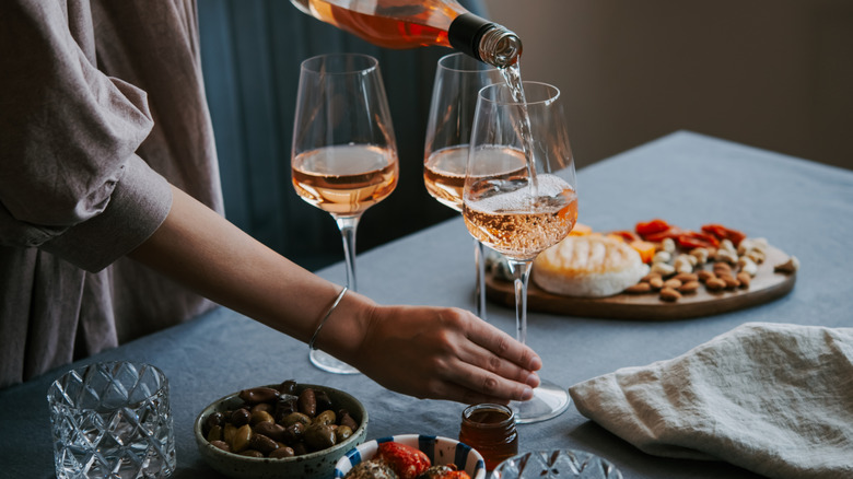 Best Italian restaurant in Seattle with waiter pouring wine into three glasses at a table
