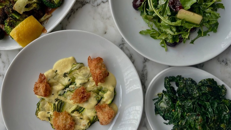 Marble counter with white plates of the best Seattle Italian restaurant food