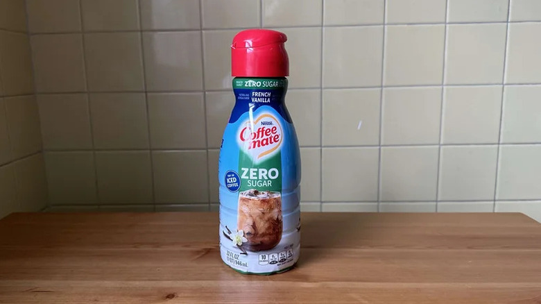 Coffee Mate French Vanilla Zero Sugar Creamer on wooden counter against beige tiles