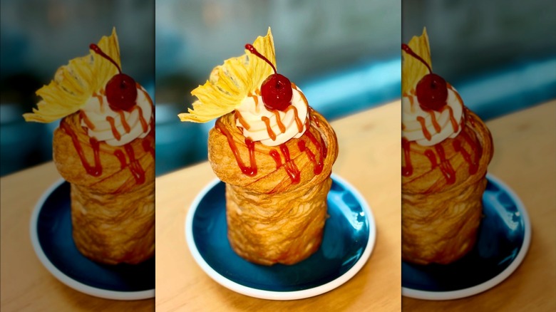 Pineapple and caramel cruffin on small blue plate at D'Andrews Bakery
