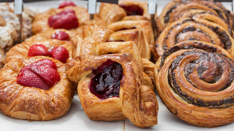 Baked goods with strawberries, jam, and chocolate on display