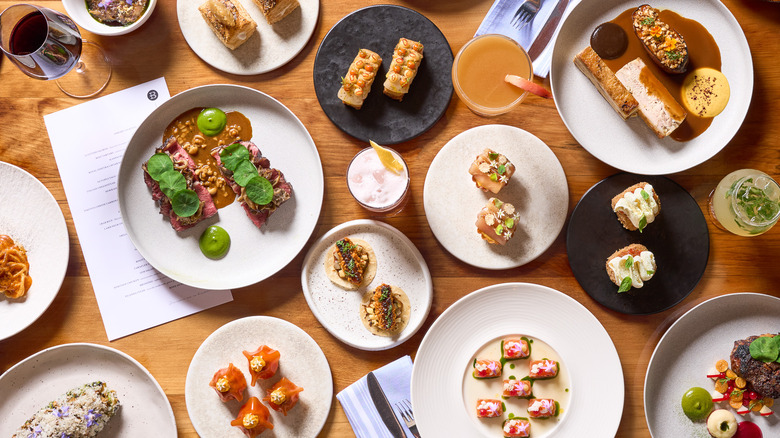 Top view of several dishes and drinks on table