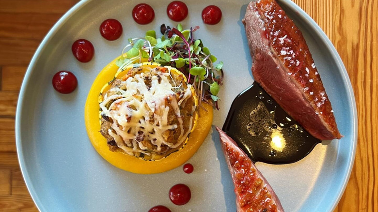 Duck breast with butternut squash puree on plate at Heirloom in Lewes