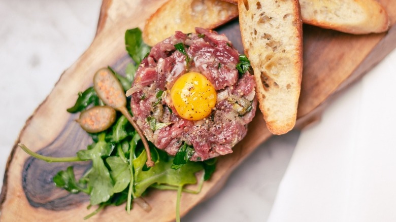 Steak tartare with toasted baguette and greens at La Fable